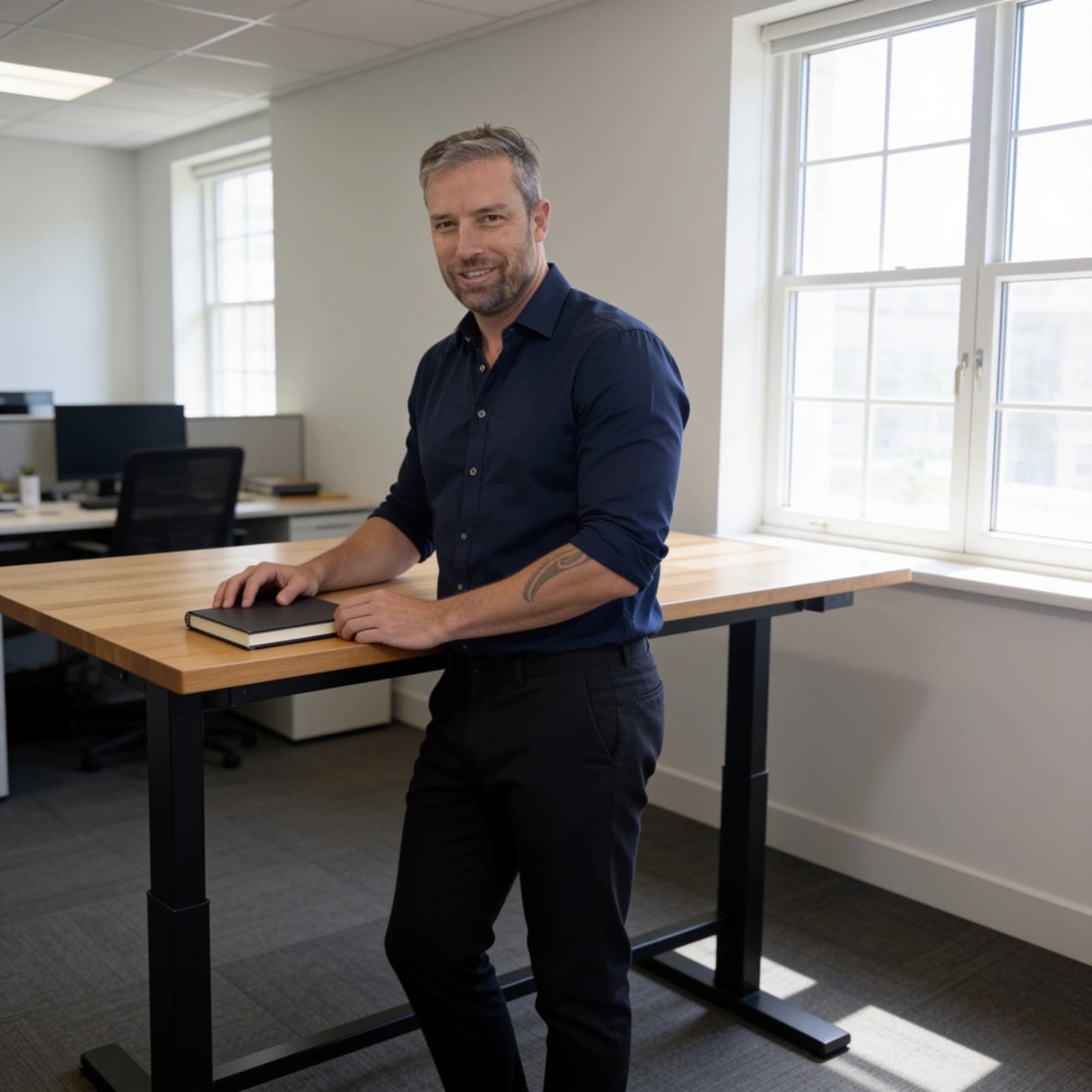 Chris Bowler, Business Process Lead at WrightOps, standing beside a desk in a navy collared shirt.